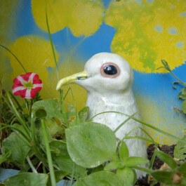 Getöpferte weiße Taube in einem Blumentopf. 